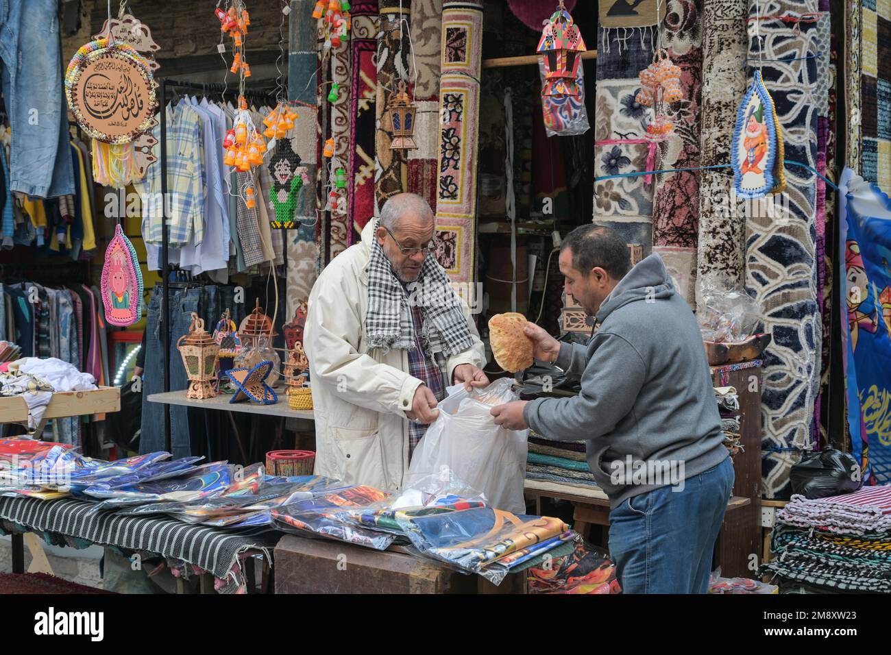 Street scene, textile shop, carpets, men, bread, Khan elKhalili bazaar