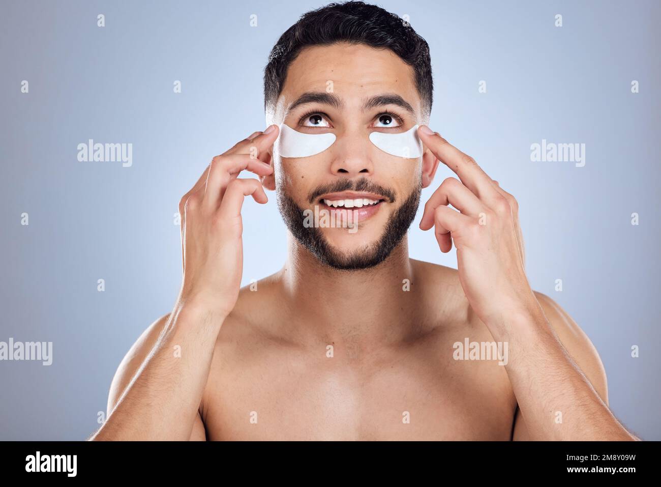 Treating his undereye skin with care. a handsome young man applying