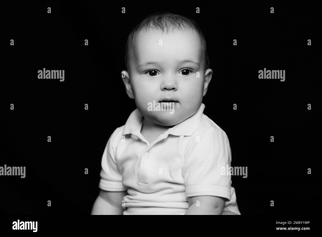 Black and white portrait of funny cute little baby. Caucasian child boy