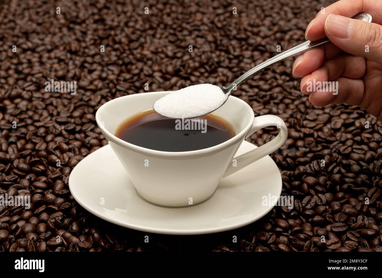 Cup of coffee on brown coffee beans Stock Photo
