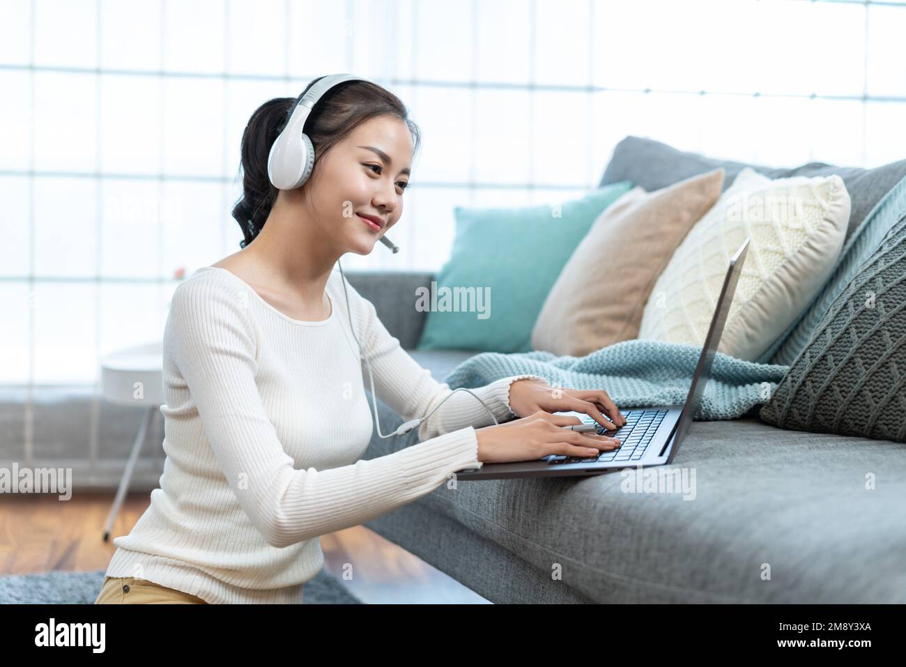 A young woman to use a computer at home Stock Photo - Alamy