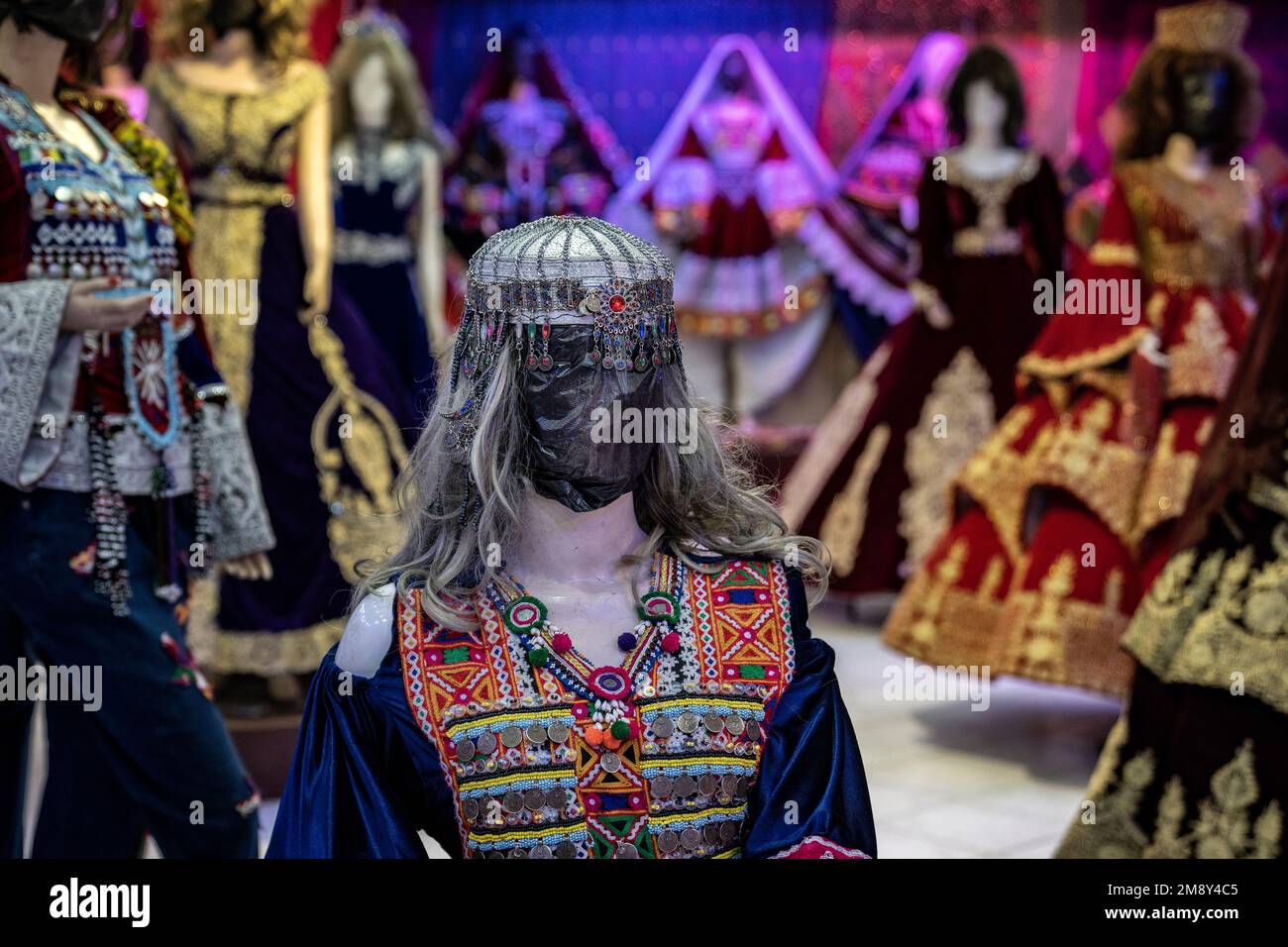 A mannequin's head is covered in a woman dress shop in Kabul