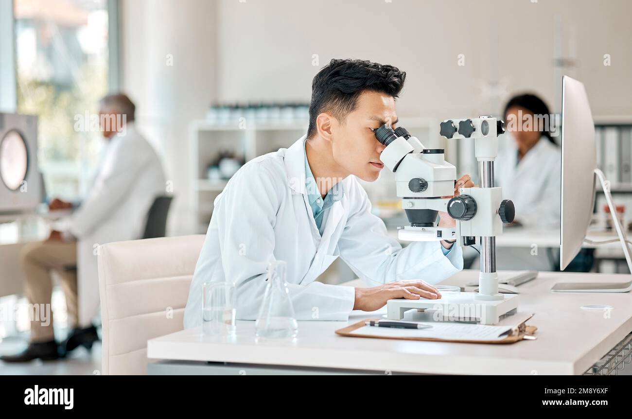 Life is all about how well you understand it. a young scientist using a microscope in a lab. Stock Photo