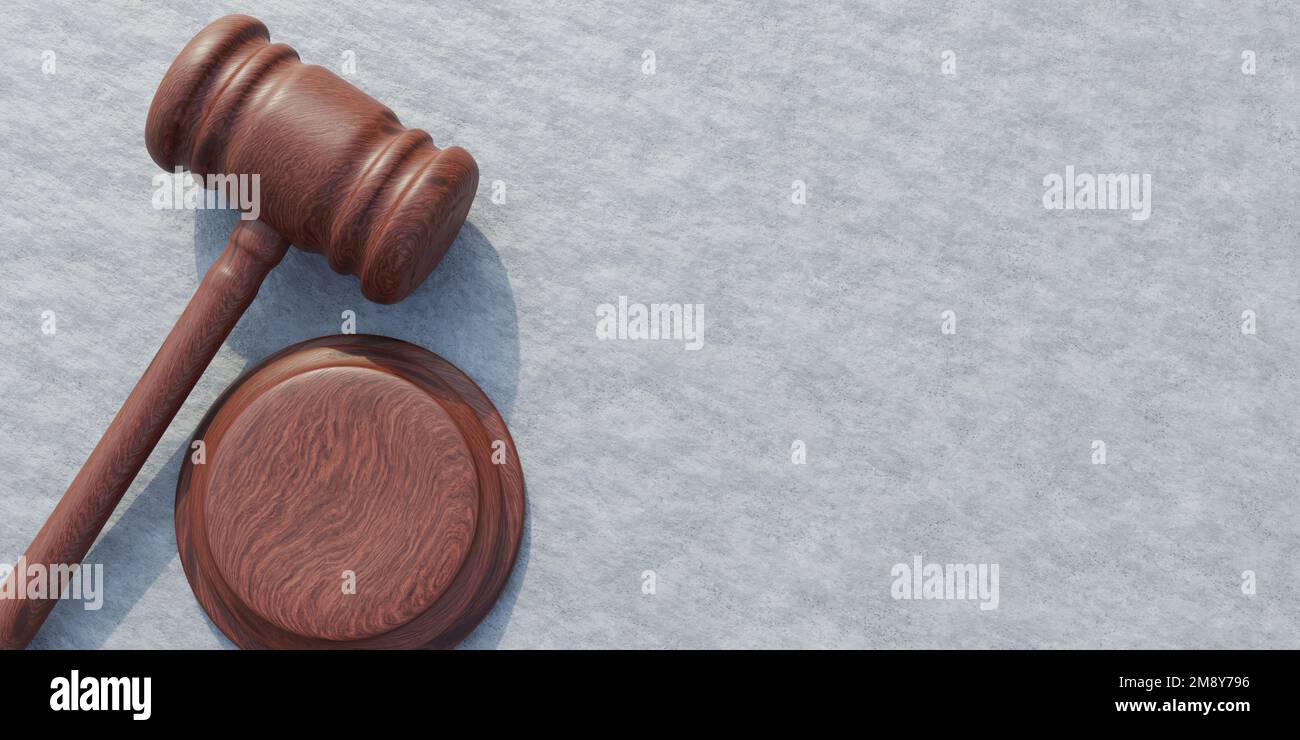Wooden judge gavel on grey concrete wall background. Brown hammer