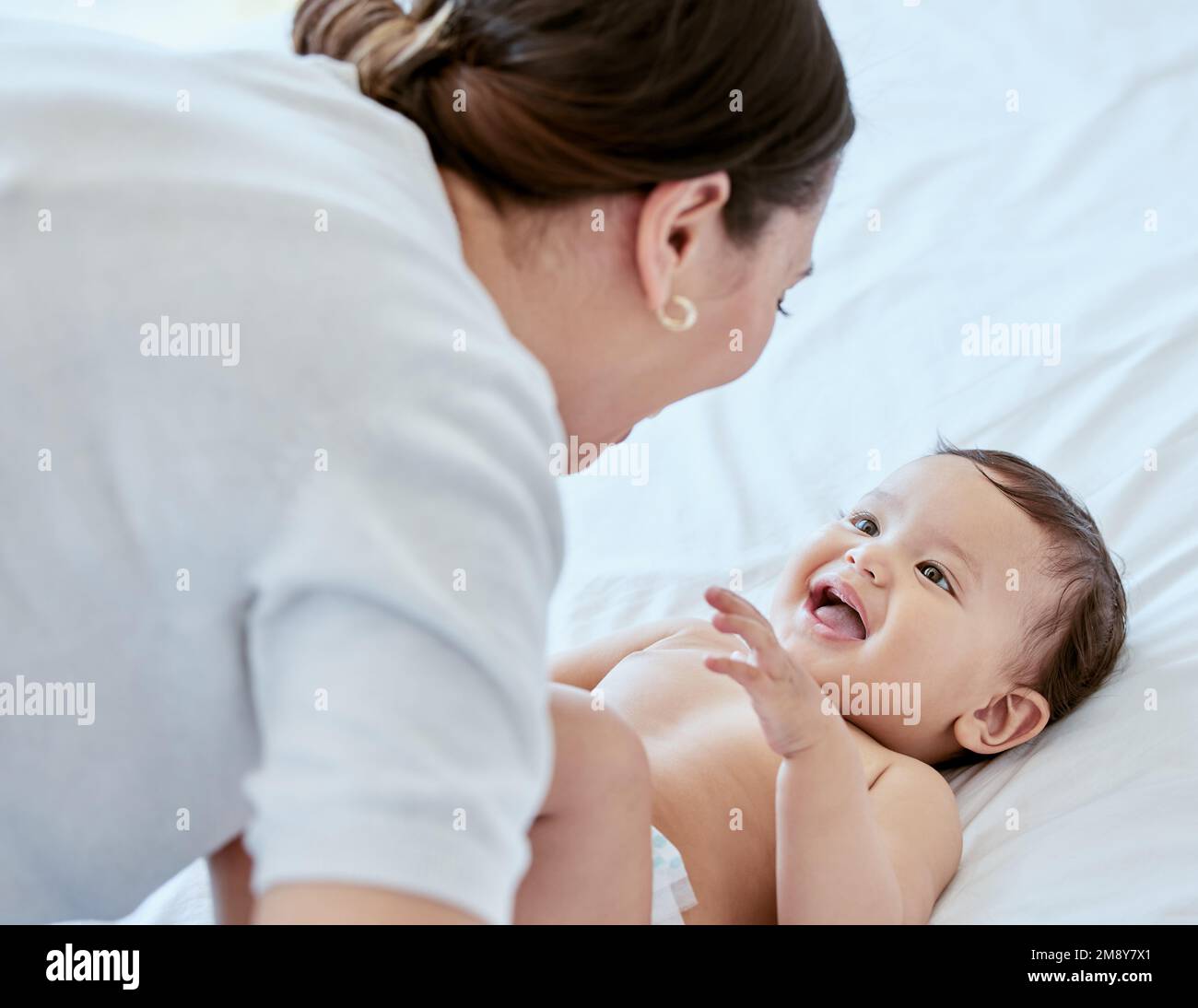 Tummy laughter. a young mother bonding with her baby at home. Stock Photo