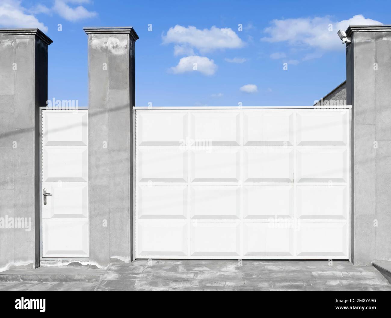 Modern white aluminium sliding gate. Gate portal of suburb door house. Stock Photo