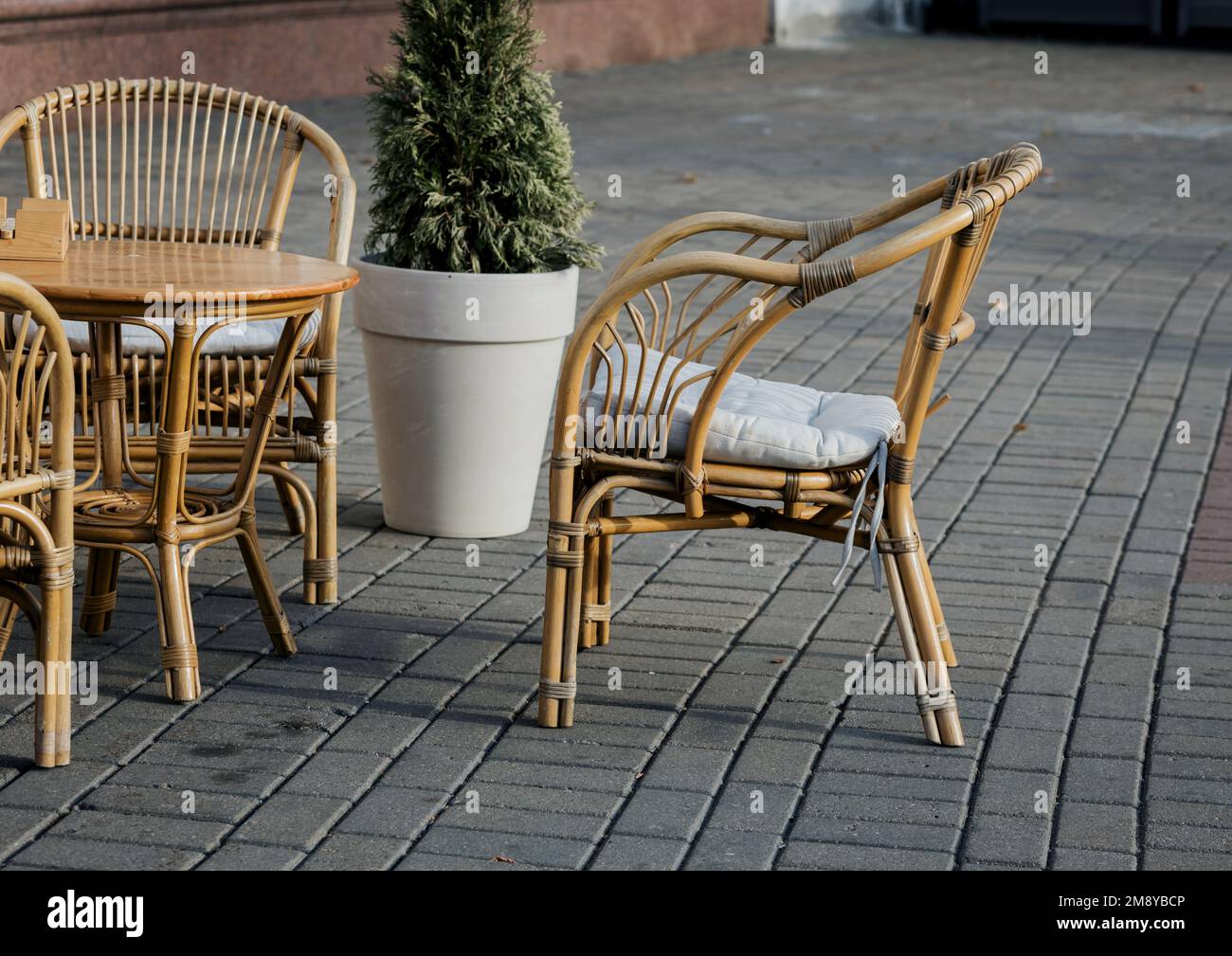 empty outdoor cafe on the veranda. rattan chairs and tables on the