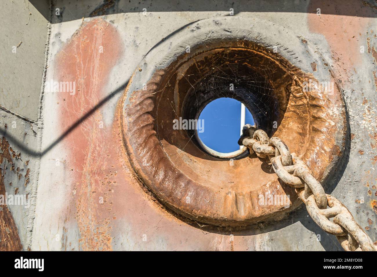 The anchor hole with a chain of an old stranded ship Stock Photo Alamy