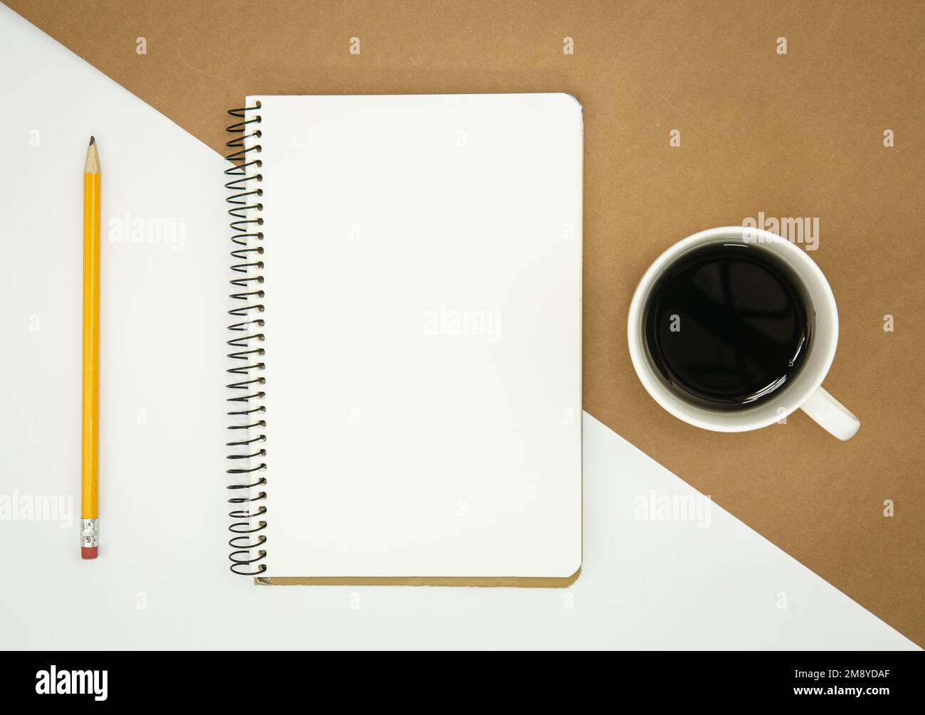Blank notepad, coffee cup and pencil, flat lay. Stock Photo
