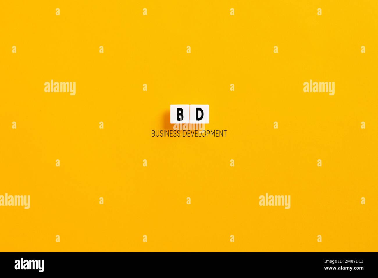 White letter blocks on yellow background with the acronym BD business development. Stock Photo