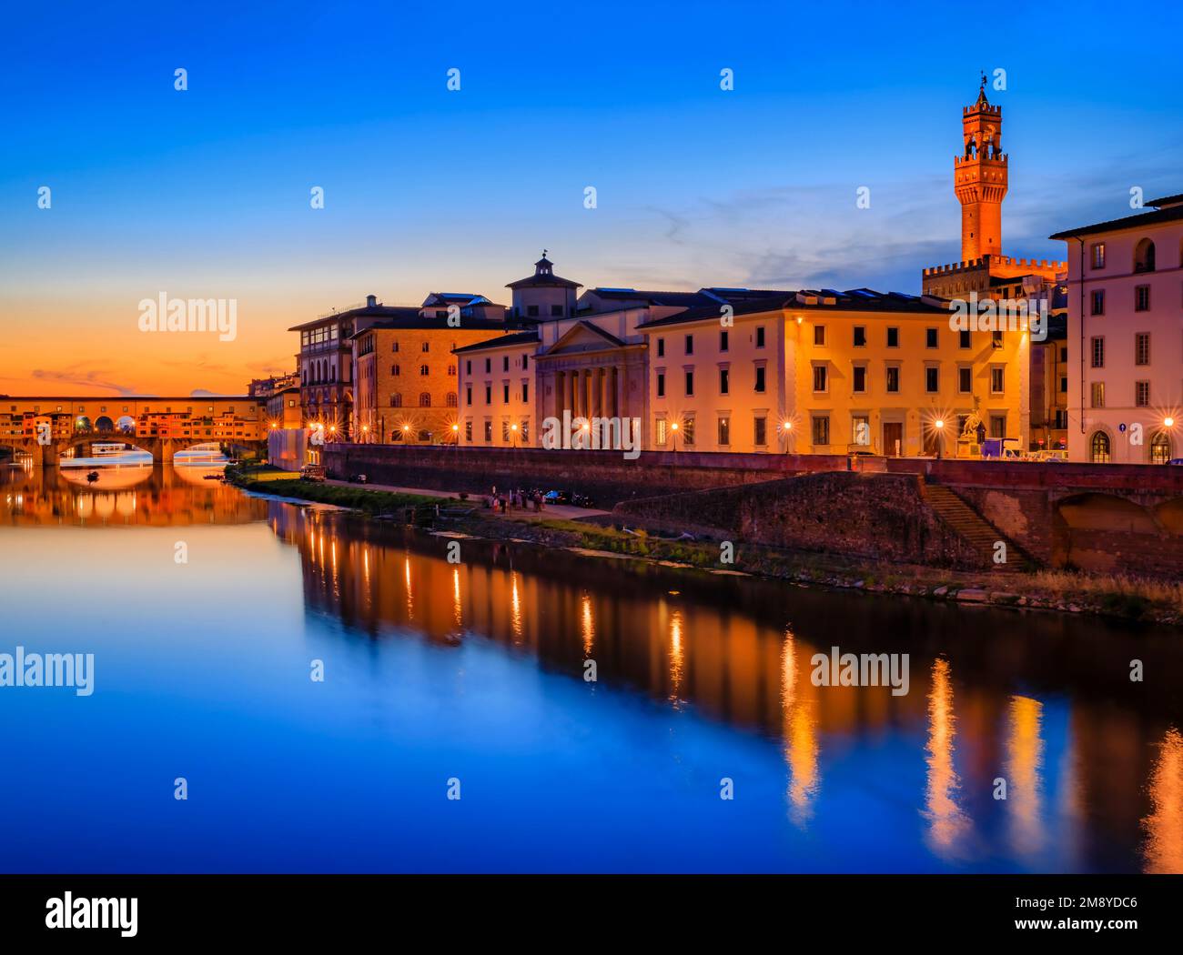 Sunset cityscape with the famous bridge of Ponte Vecchio on the river Arno River and Palazzo Vecchio in Centro Storico, Florence, Italy Stock Photo