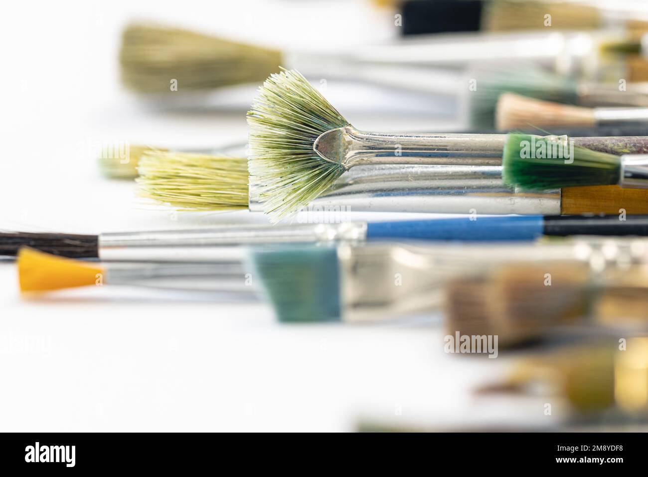 Paint brushes stained with paint, close-up, macro shot. Stock Photo