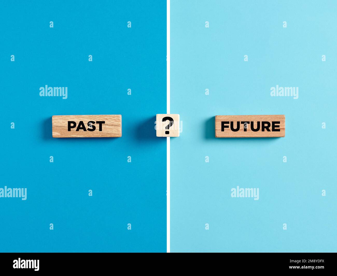 The words past and future on wooden blocks with question mark symbol. Dilemma or choice between the past and future concept. Stock Photo