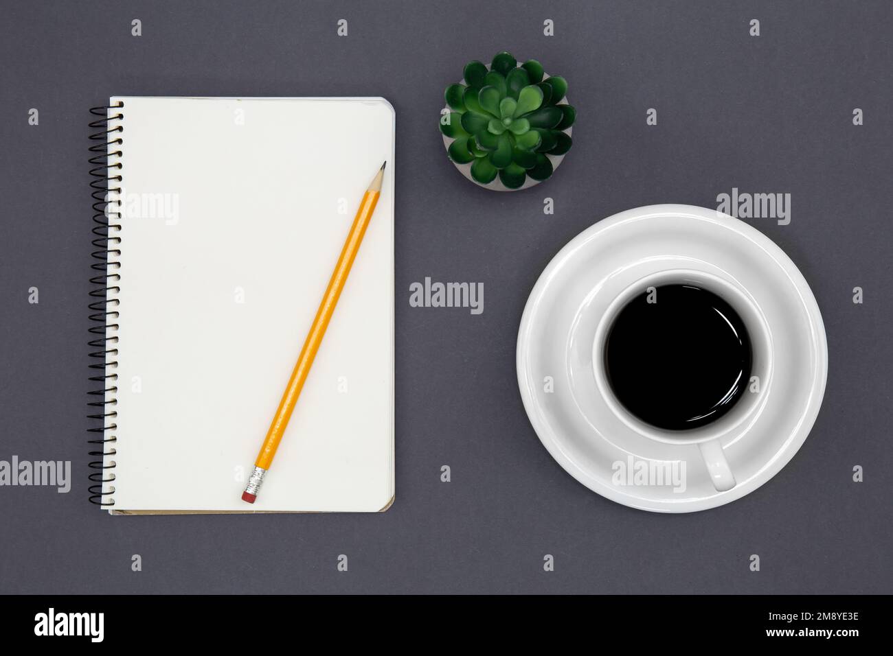 Blank notepad and coffee cup, conceptual minimalism. Stock Photo
