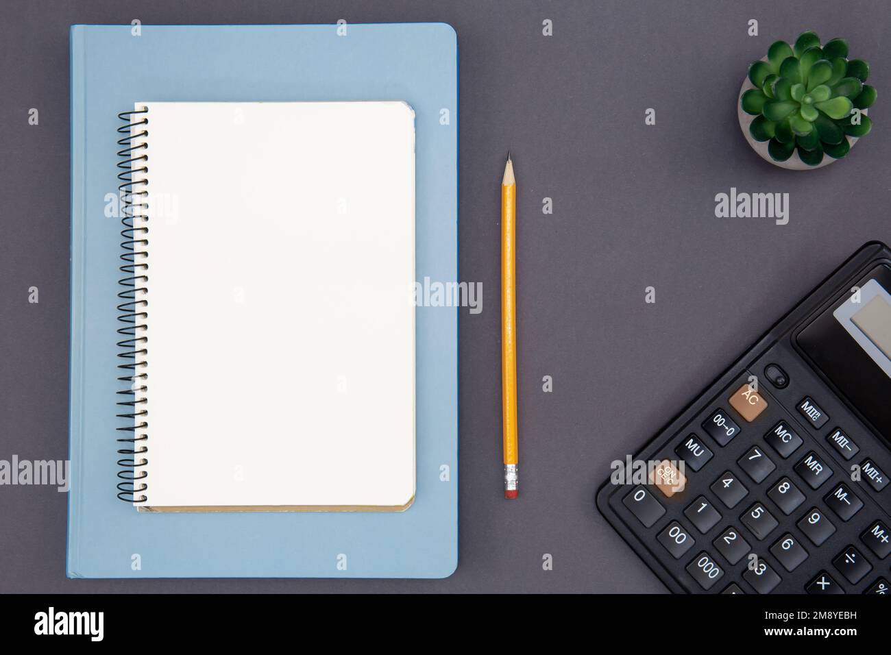 Blank notepad, calculator and pencil, top view. Stock Photo