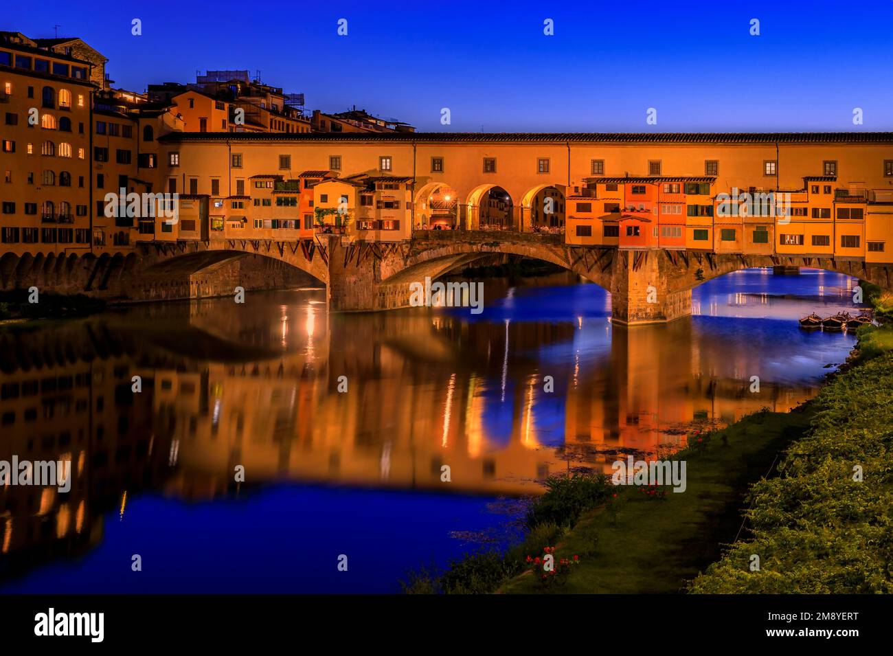 Close up of silversmith shops on the famous Ponte Vecchio bridge on the Arno River in Centro Storico, Florence, Italy at sunset Stock Photo