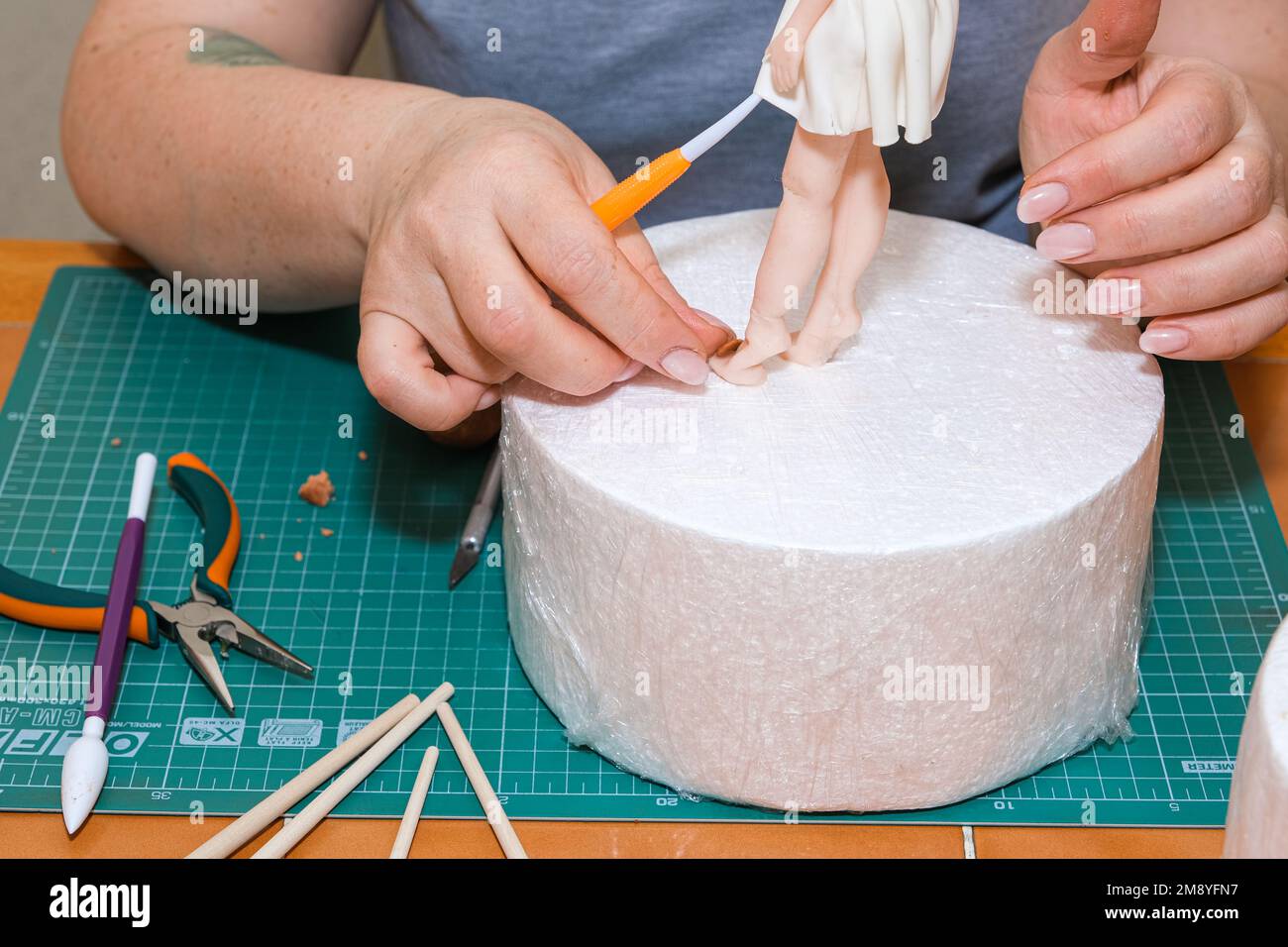 master in the modeling of figures from confectionery mastic Stock Photo