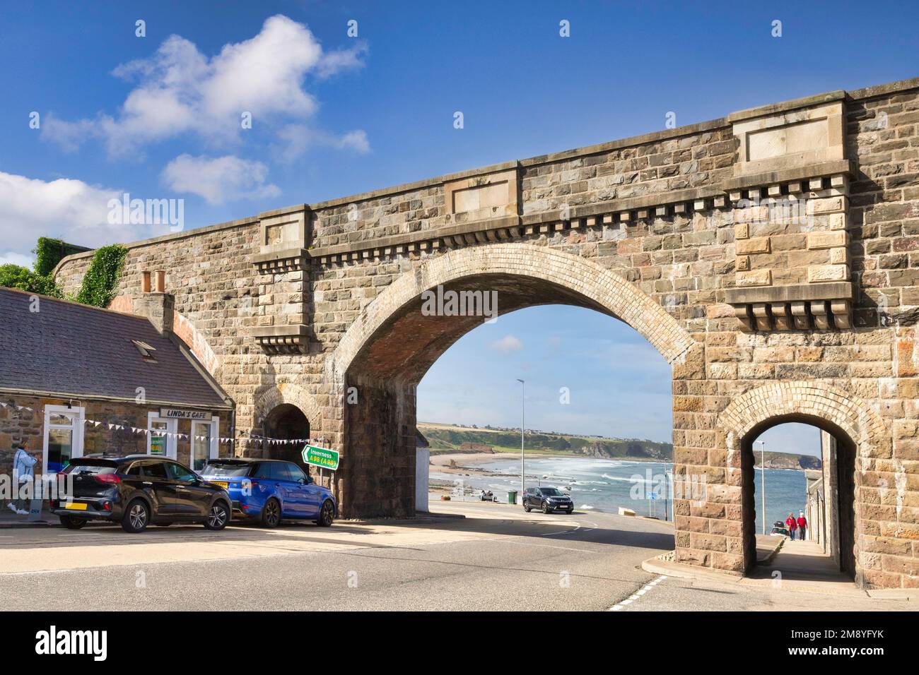7 September 2022: Cullen, Moray, Scotland - The railway bridge over Seafield Street, with a view through the arch to the beach. Stock Photo