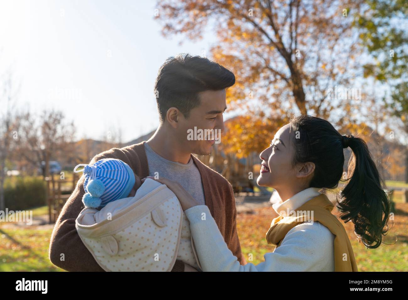 A young couple holding a baby Stock Photo