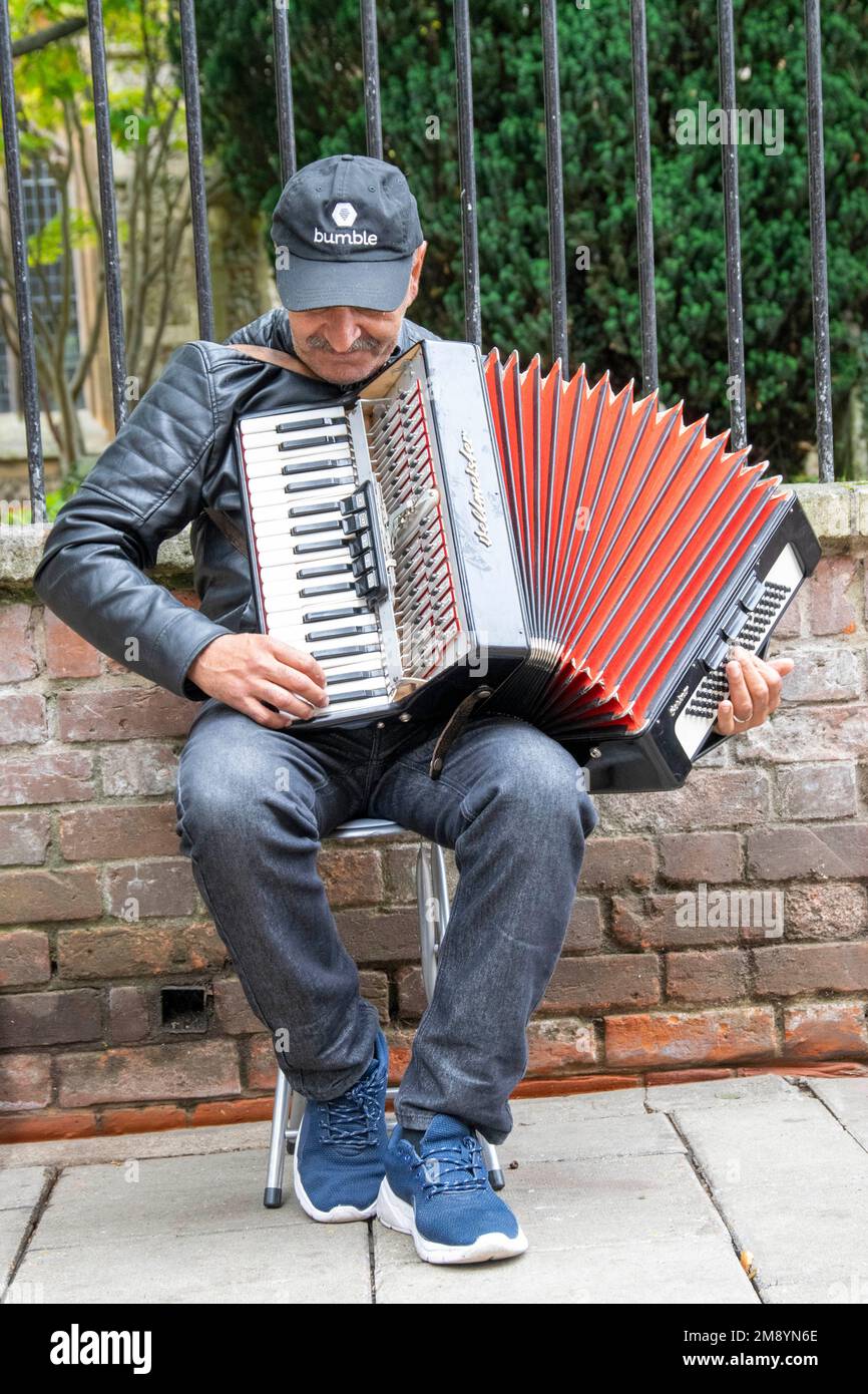 Busker with Accordian, playing music to the public Stock Photo