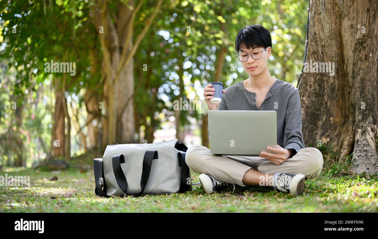 Handsome and smart young Asian male college student wearing glasses ...
