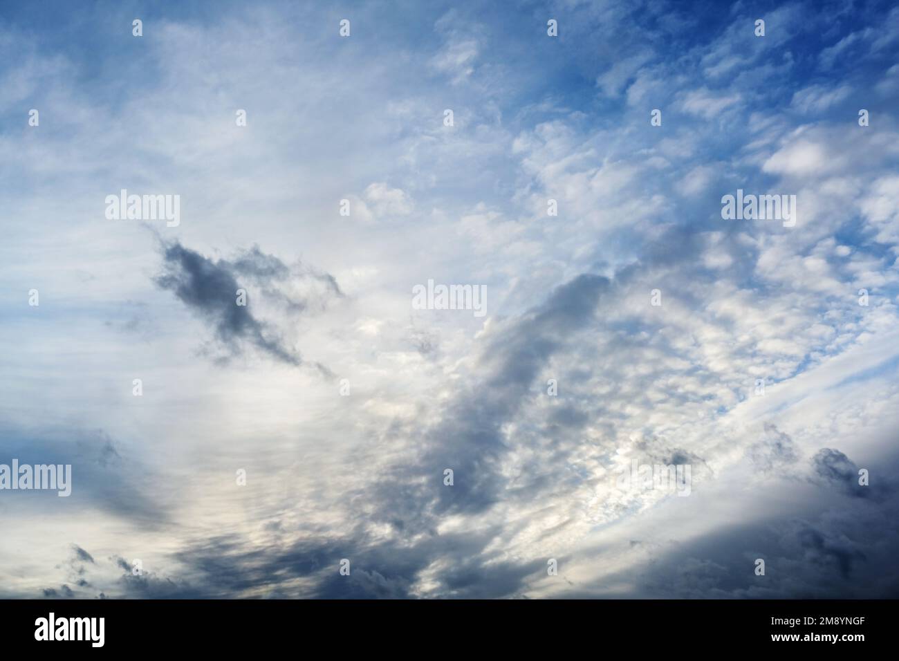Light and dark clouds on the blue sky on a stormy day, natural background, concept for weather forecast and meteorology, copy space, soft focus Stock Photo