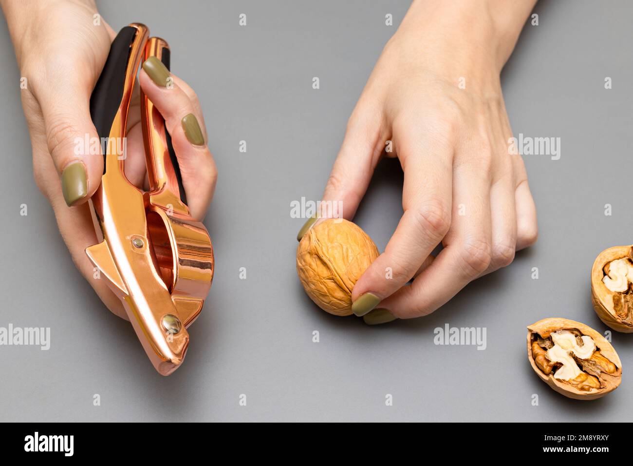 man cracking a walnut with a nutcracker. man cracking a nut. nut
