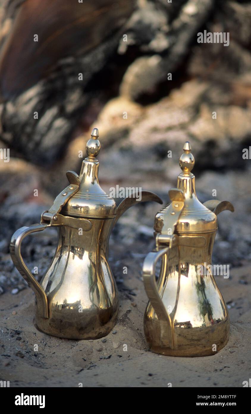 Bahrain, traditional Arabic brass dallah coffee pots in the coals of a fire Stock Photo Alamy