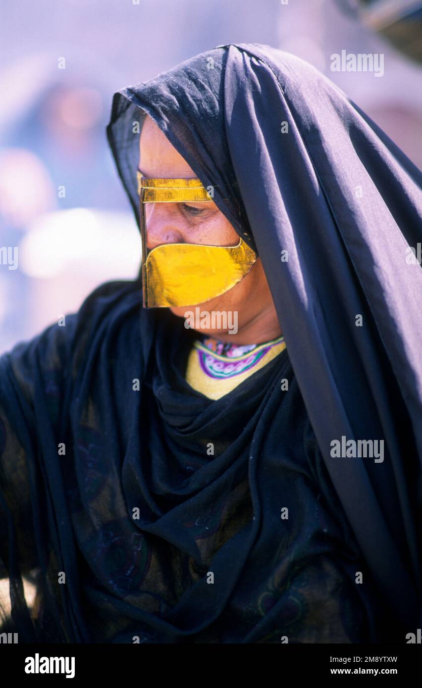 Bahrain, woman with traditional dress and burghu face covering Stock