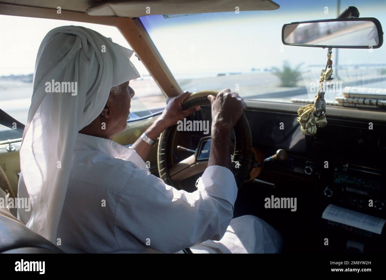 Bahrain a traditionally dressed Bahraini driving taxi cab Stock Photo ...