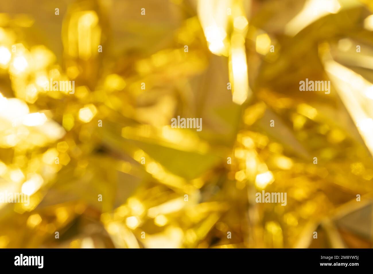 defocused crumpled gold foil, fashion texture background Stock Photo