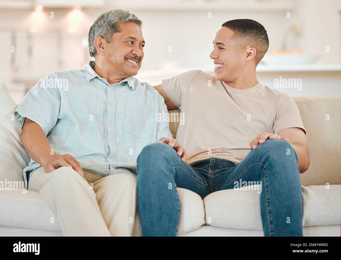 Is that how it goes. a father and son bonding on the sofa at home. Stock Photo