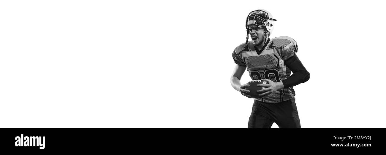 Black and white photo. Man, american football player in uniform posing