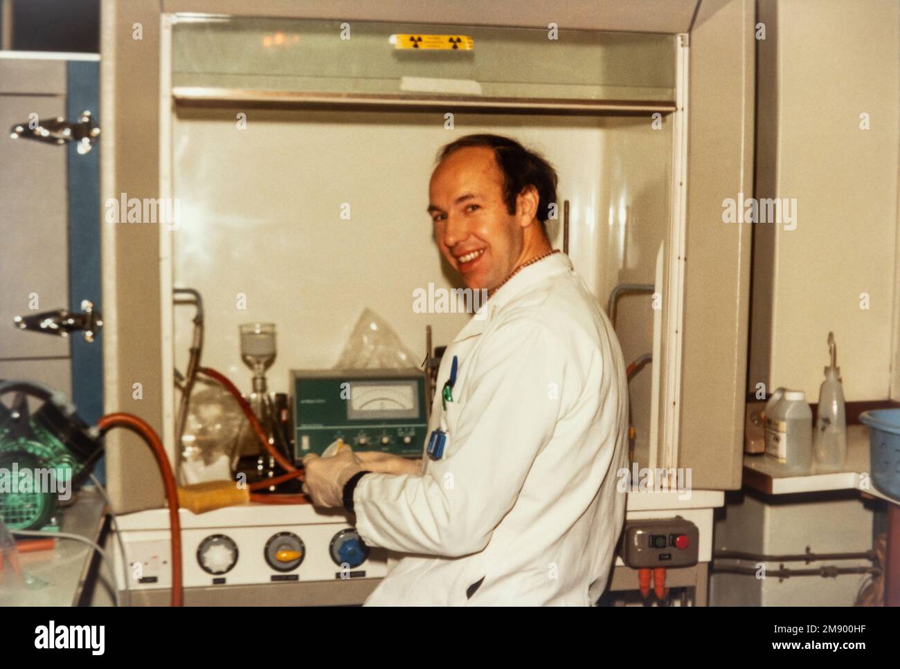 Scientist working in a biochemistry lab laboratory at a fume hood, archival photo from around 1984, England, UK Stock Photo