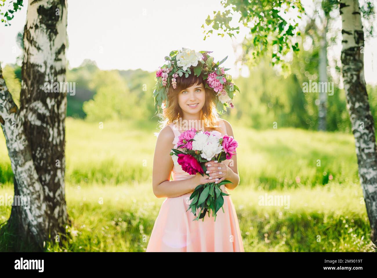portrait of a young Caucasian girl with a wreath on her head and a ...