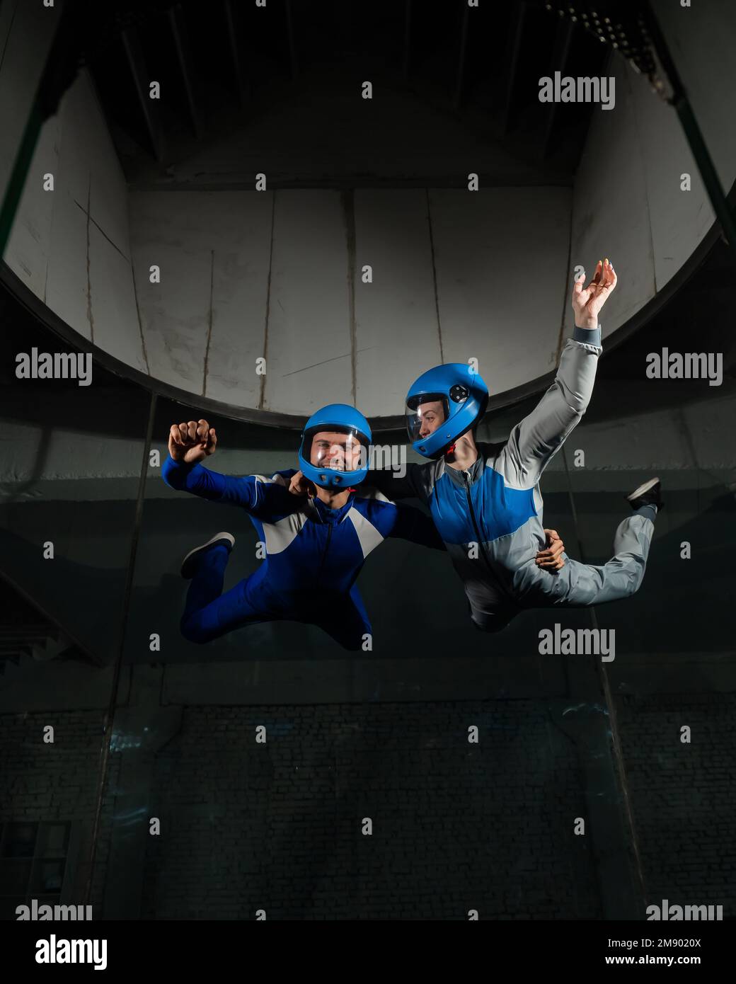 A man and a woman enjoy flying together in a wind tunnel. Free fall ...