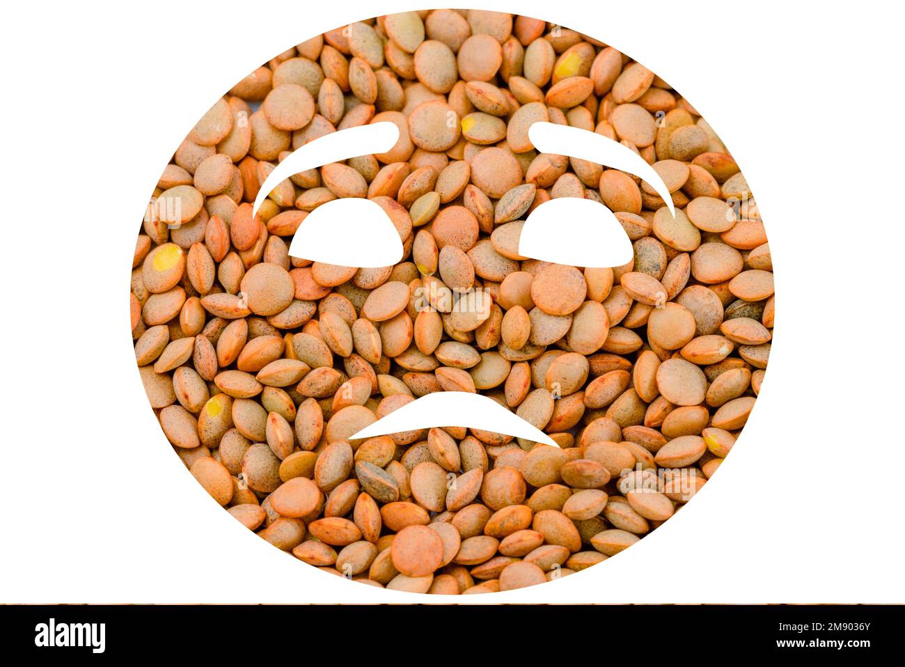 Lentil beans arranged on a white background to look like an emoji Stock Photo