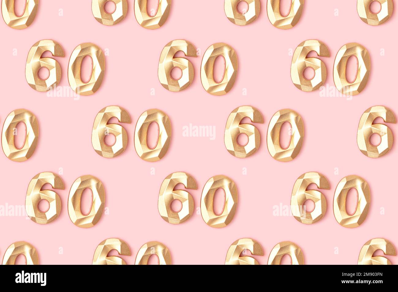 Pattern made of gold colored number sixty on a pink pastel background. Stock Photo