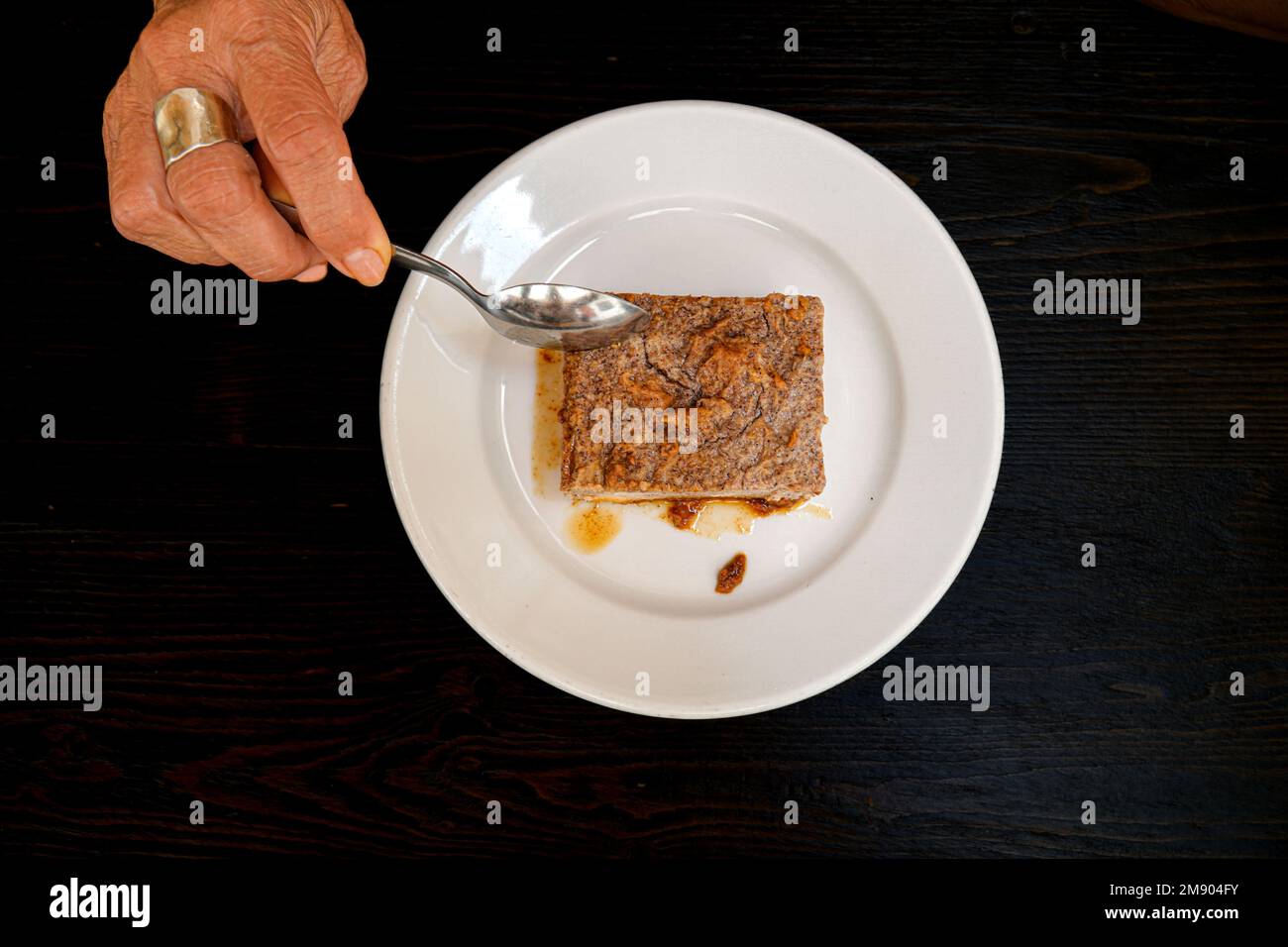 Eating greixonera, a typical Ibiza dessert. Traditional Ibiza ensaimada ...