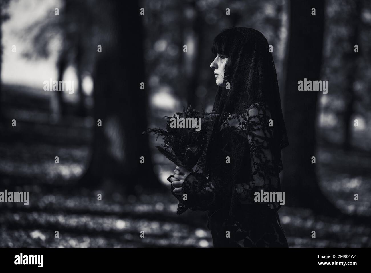 A grayscale of a scary corpse bride in the autumn forest Stock Photo