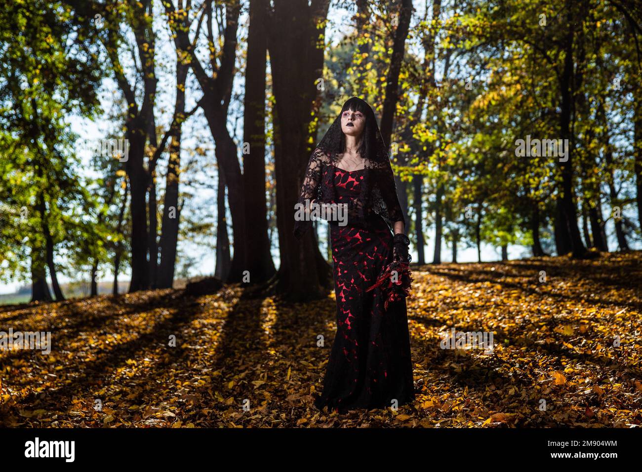 A scary corpse bride in the autumn forest Stock Photo