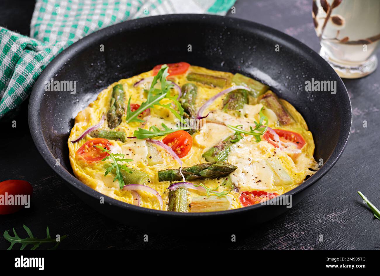 Healthy asparagus omelette. Eggs omelet with asparagus, tomatoes, and