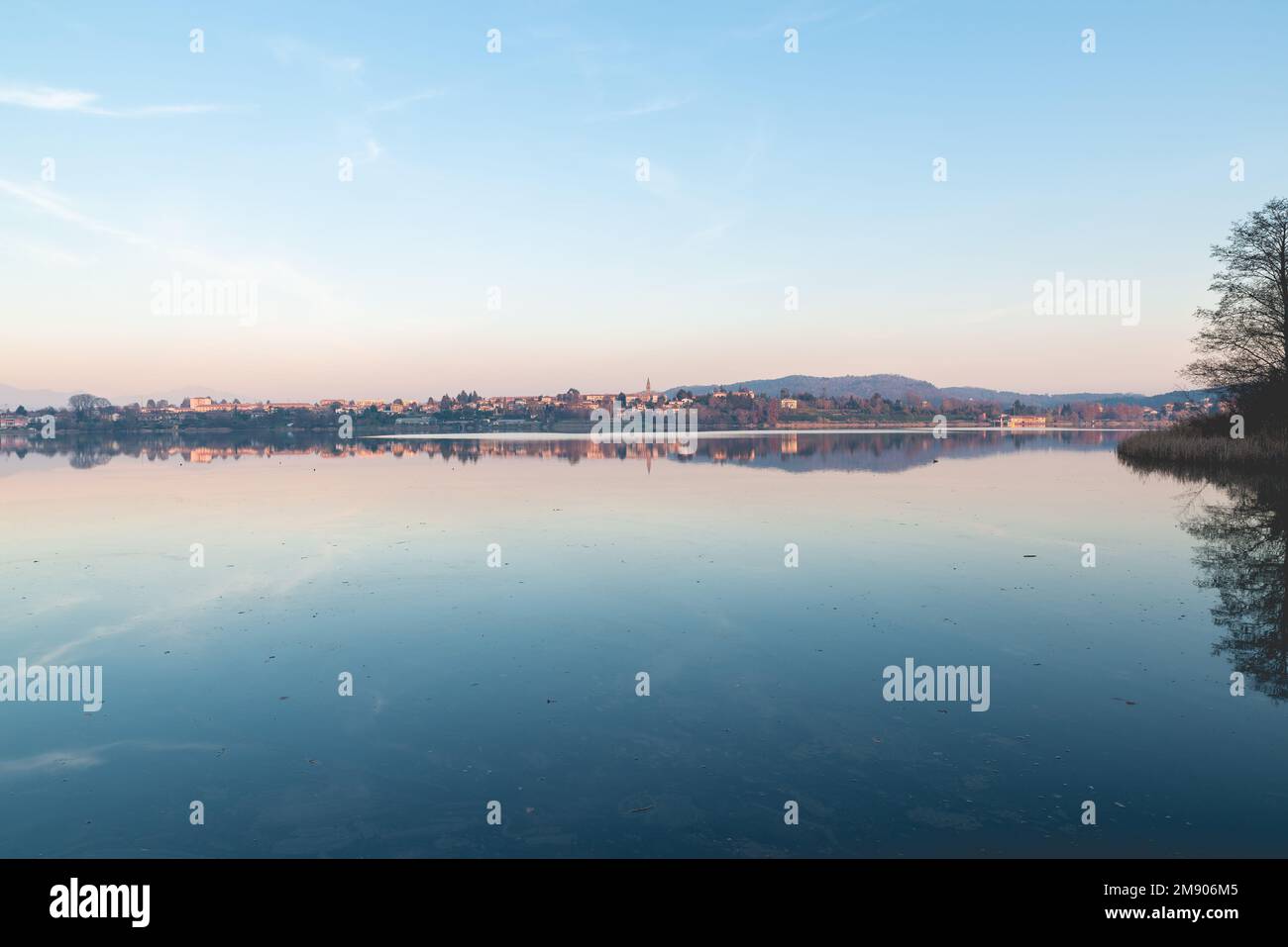 Sunset on lake. Comabbio lake and Varano Borghi town, Italy Stock Photo