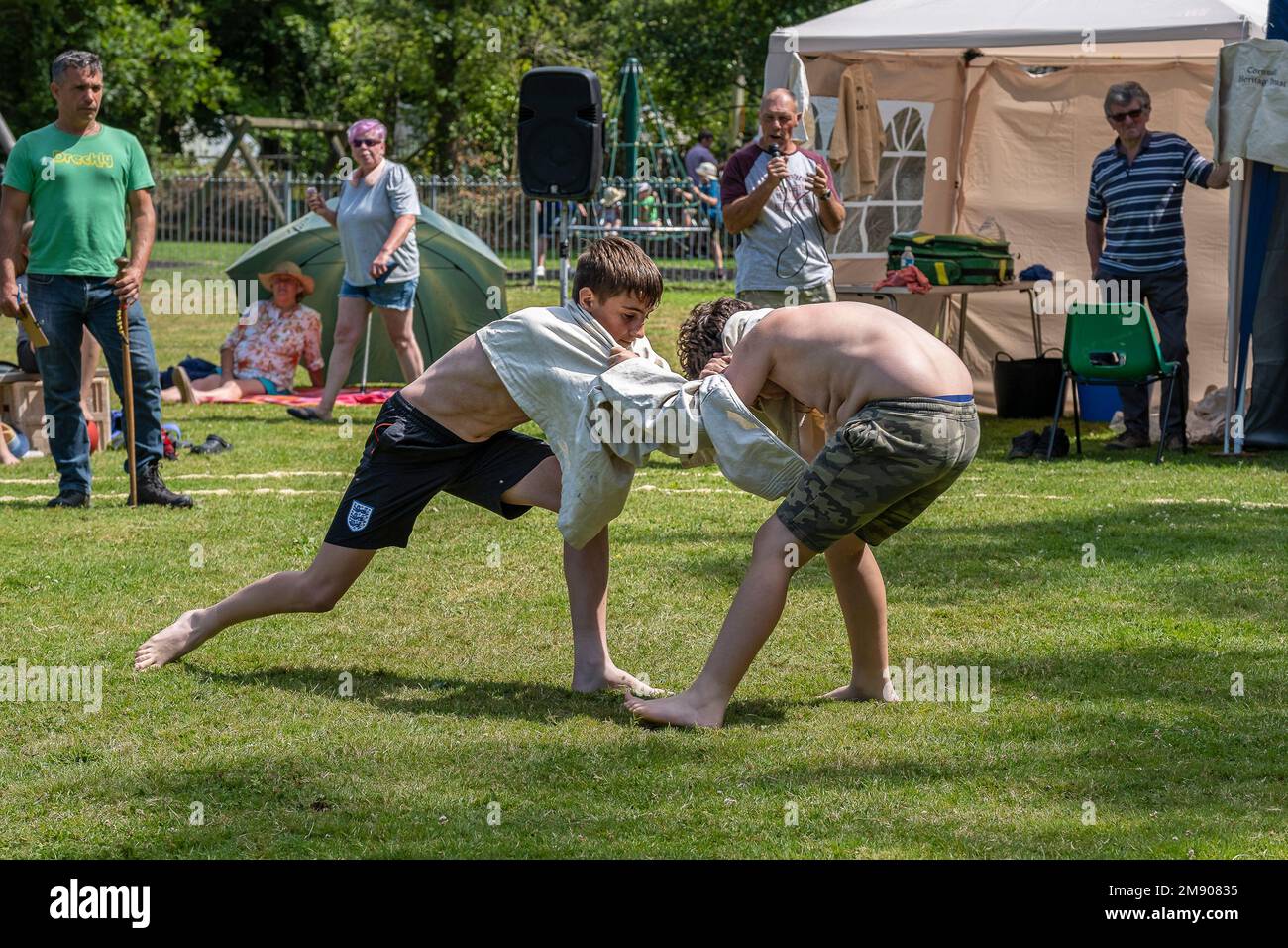 Two young teenagers competing in the Grand Cornish Wrestling Tournament on the picturesque village green of St Mawgan in Pydar in Cornwall in England Stock Photo