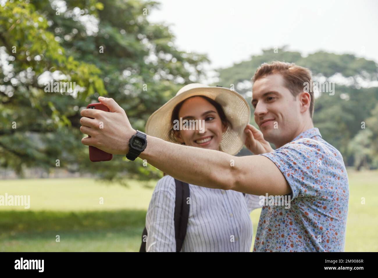 happy young smiling couple selfie with smart phone in summer travel on vacation. man and woman couple lover taking self portrait with outdoor nature p Stock Photo