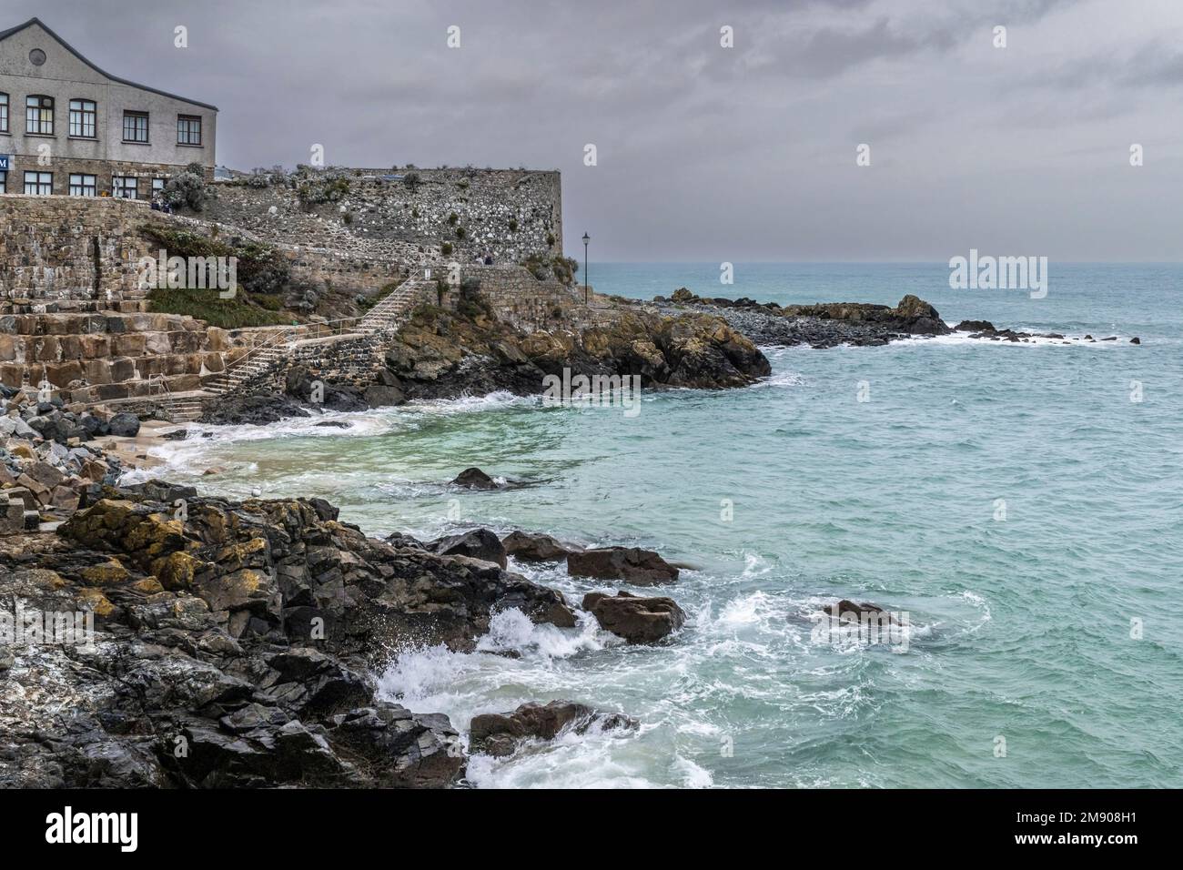 UK weather. High tide at Bamaluz Beach on rainy chilly miserable day in the historic seaside town of St Ives in Cornwall in England in the UK. Stock Photo