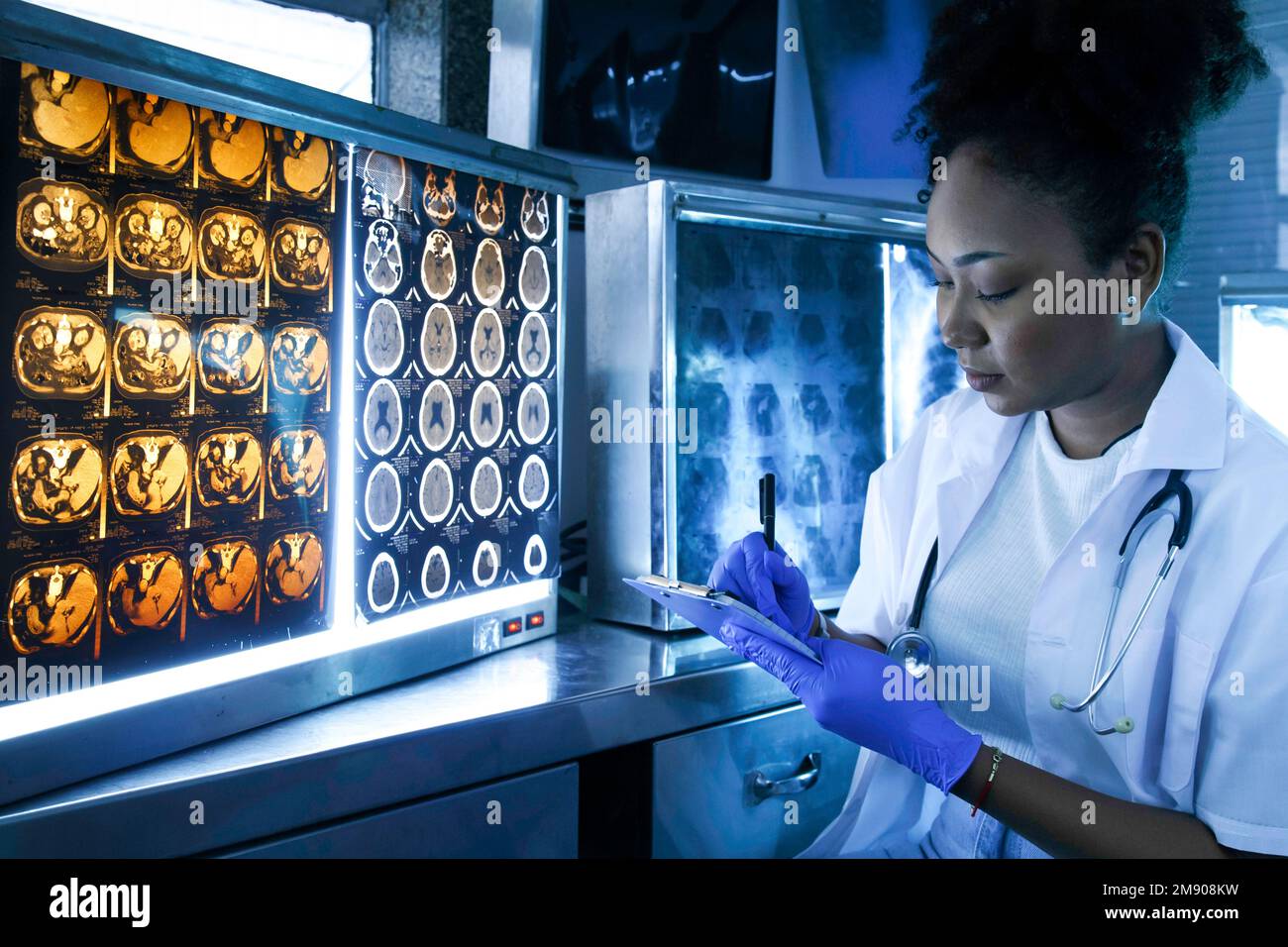 Female medical radiologist doctor looking head and brain x-ray film before surgery in lab office at hospital. Healthcare and education. Stock Photo