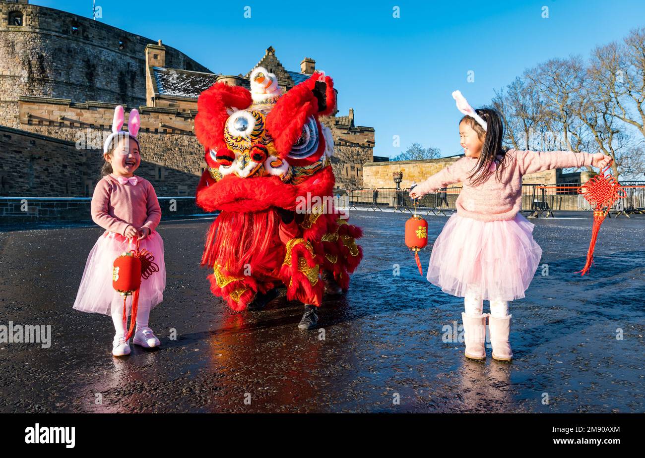 Edinburgh, Scotland, United Kingdom, 16th January 2023. Launch of Chinese New Year celebrations: children Luna Chen and Annabelle Ye (both 5 years old) and dragon dancers on the castle esplanade launch the capital city’s Chinese New Year festivities. Credit: Sally Anderson/Alamy Live News Stock Photo