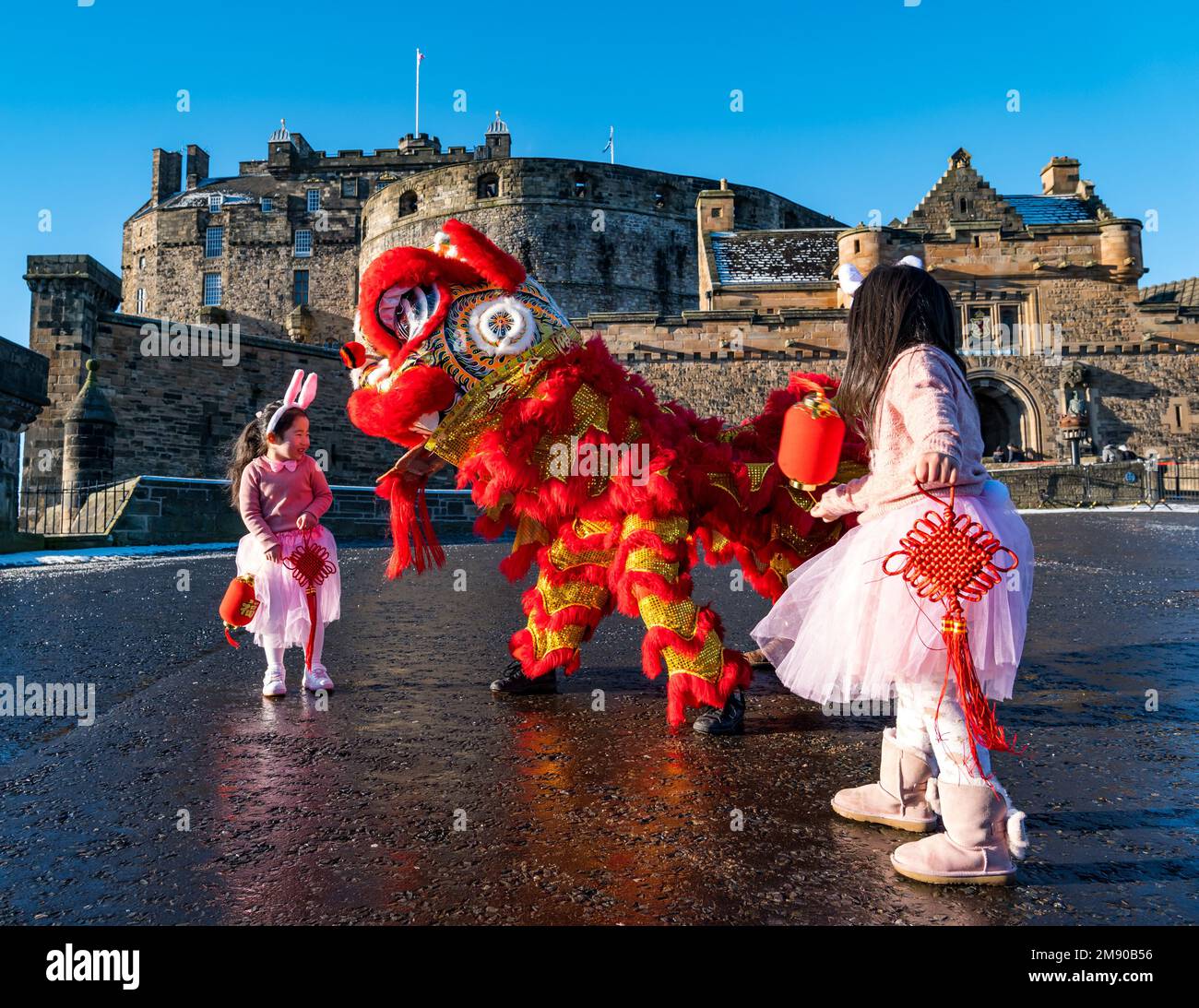 Edinburgh, Scotland, United Kingdom, 16th January 2023. Launch of Chinese New Year celebrations: children Luna Chen and Annabelle Ye (both 5 years old) and dragon dancers on the castle esplanade launch the capital city’s Chinese New Year festivities. Credit: Sally Anderson/Alamy Live News Stock Photo