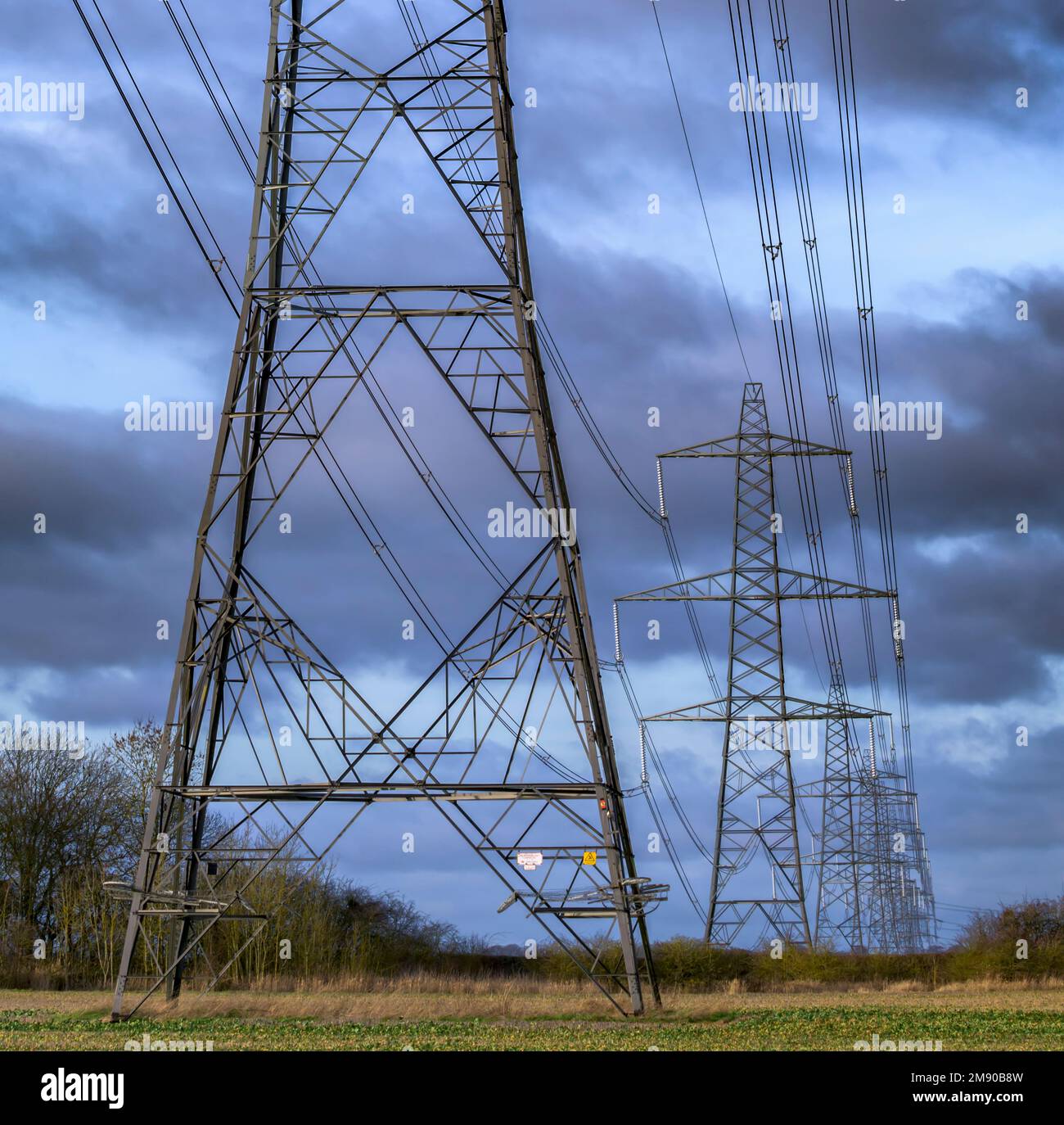 Lincolnshire, England UK - Electricity pylons running across farmland in Lincolnshire Stock Photo